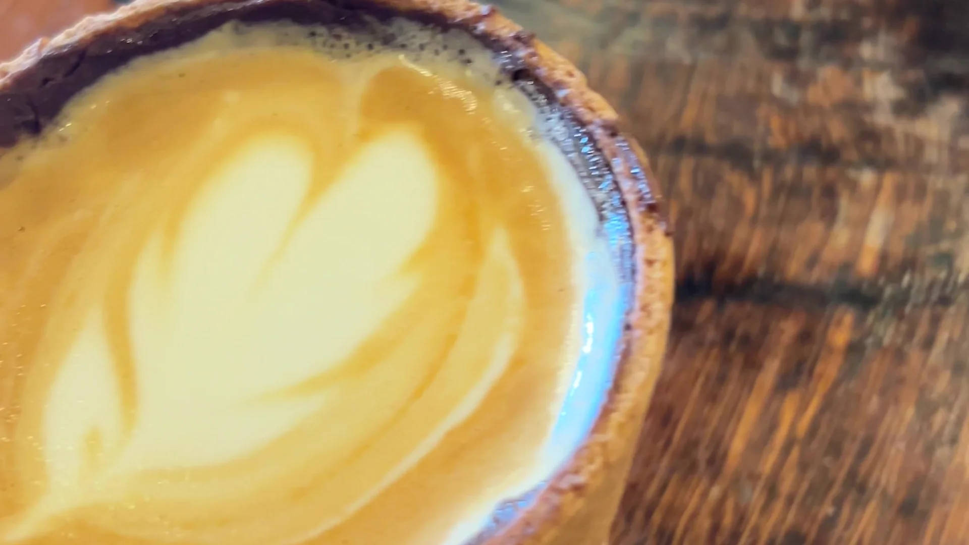 Barista pouring intricate rosette latte art