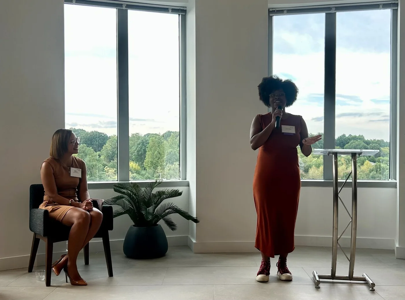 Brittani speaking with a microphone at the September 30 AEDP Annual Impact Event