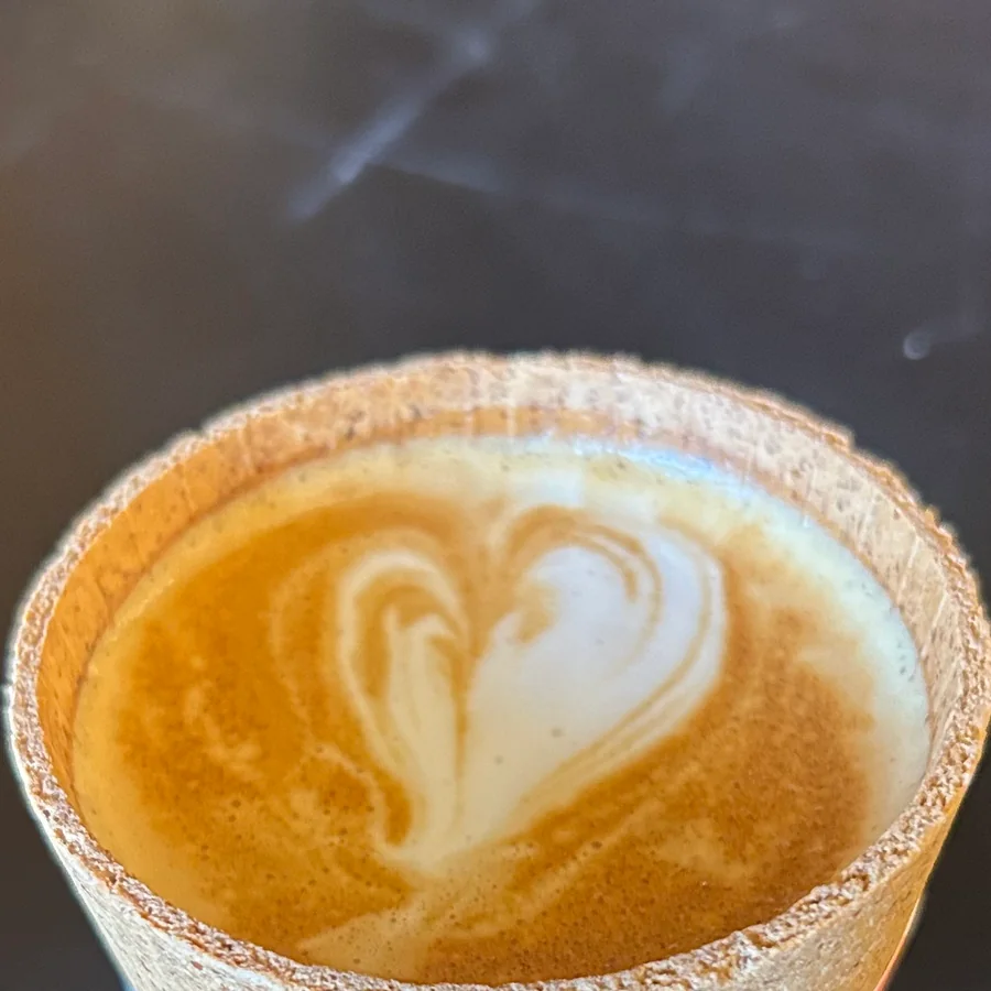 Artisanal cocoa-rimmed latte prepared fresh at Dream Chasers Coffee Lab