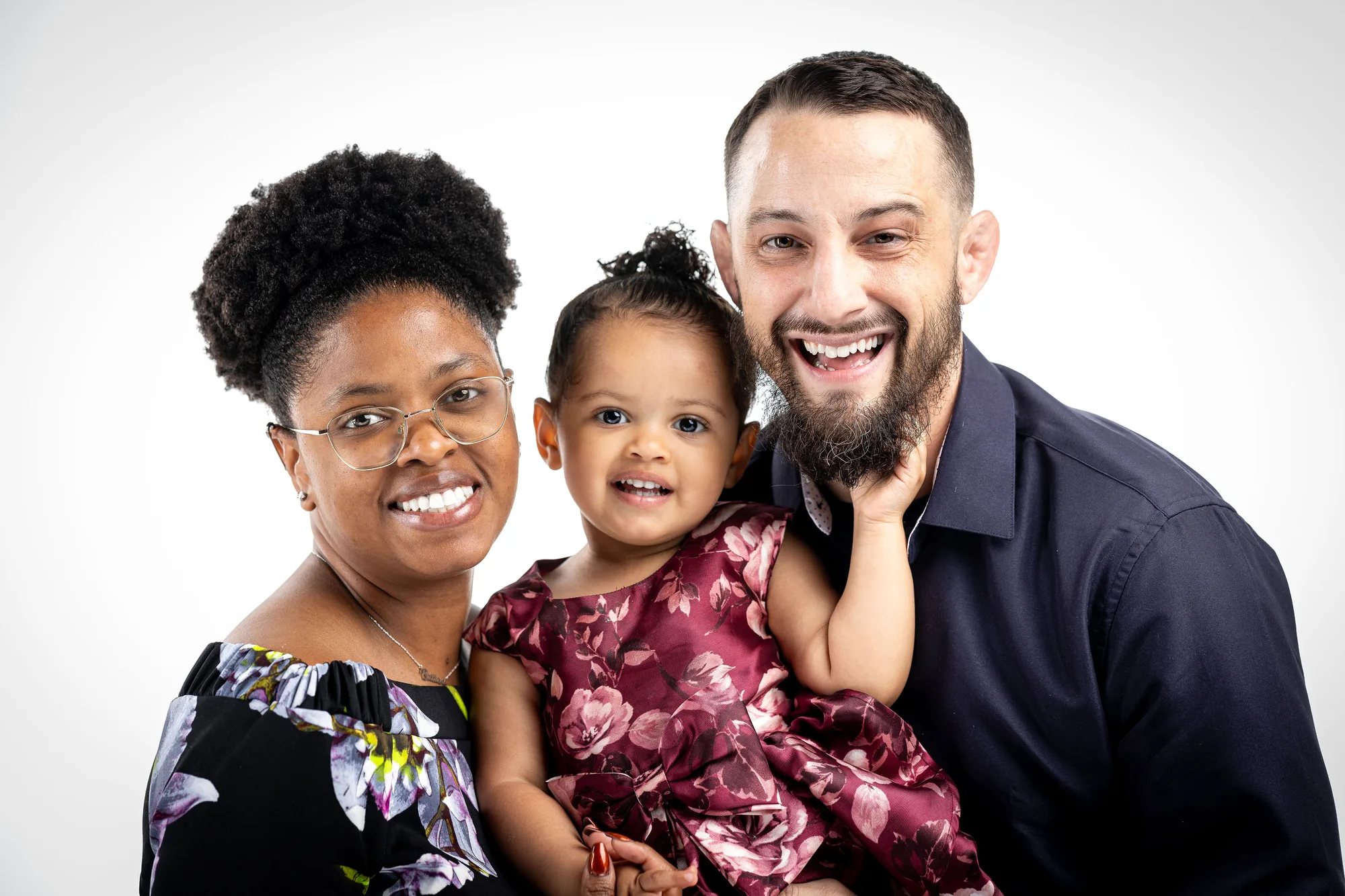 Leo, Brittani, and daughter Meccah smiling together